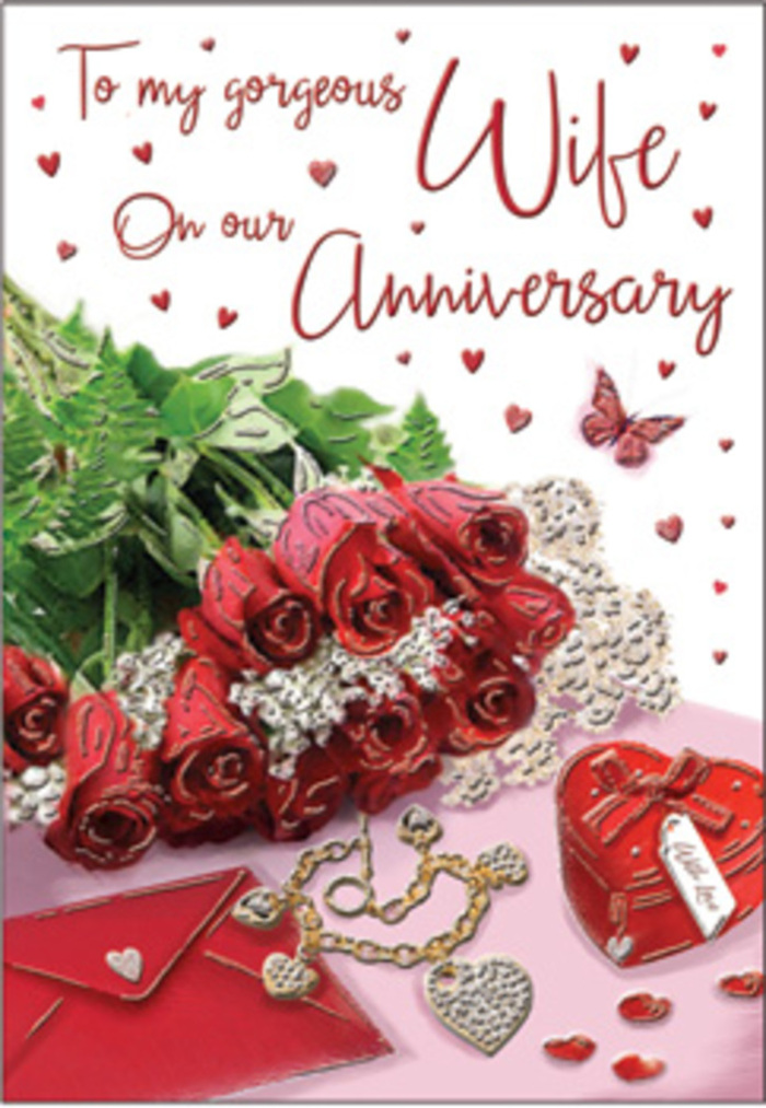 In this richly detailed anniversary card image, the eye is immediately drawn to a bouquet of classic red roses, each bloom luxuriously full and carefully arranged, just as a Greenwich florist might prepare a hand-tied gift for a special evening. Their deep crimson petals form tight spirals at the centre, gradually unfurling into softer, rounded edges, capturing that blend of passion and comfort that long-term love often holds. These roses are nestled among lush green leaves, their surfaces smooth and slightly glossy, adding volume and life while echoing the greenery that lines the paths between Greenwich town centre and the river. The bouquet is set on or across an elegant card, where a scripted anniversary message is partially visible, the writing graceful and flowing, suggesting that every word has been thoughtfully chosen. Surrounding the roses are romantic details that enrich the story: a jewellery set or delicate necklace, shimmering softly on the surface; a vivid red box, likely a gift box for earrings or a pendant; and small heart motifs scattered like shared memories across the background. The textures in the scene-hint of lace, polished metal, smooth card, and soft ribbon-play against one another, creating a tactile richness you can almost feel beneath your fingertips. Tiny hearts and a lone butterfly image add a light, uplifting touch, reminiscent of watching butterflies drift through the flowerbeds near Greenwich Park on a summer afternoon. The lighting is gentle and warm, without harsh shadows, as if captured near a bright sash window. The composition, as a whole, feels like a keepsake moment frozen in time: a romantic, quietly luxurious celebration of an anniversary, crafted with sensitivity and a florist's practiced sense of balance and emotion.