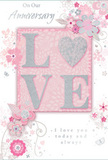 This anniversary card offers a gentle vision of enduring romance, composed in the softest palette of pastel pinks, powdered greys, and pearly whites. At the centre, the word "LOVE" is spelled out in softly rounded, raised letters, their surfaces dusted with fine glitter that shifts from blush to silver as the light moves, much like the changing reflections along the riverfront in Greenwich. The letterforms look pleasantly tactile, giving the impression of a subtle, velvety texture that invites touch. In a delicate twist, the "O" is transformed into a shimmering heart, defined in textured silver that stands out against the blush-toned background while still harmonising with the rest of the design. Surrounding this focal point, clusters of stylised blossoms unfold in blush and mauve tones, painted with an almost watercolour softness. Their petals blur gently at the edges, as though captured in a light spring breeze over Greenwich Park's flower beds. Slender vines and swirls of foliage weave between the flowers, and tiny accents-scattered petals, airy curls, and the faint outline of butterflies-add a hint of motion and whimsy without overwhelming the scene. The backdrop remains a calm, washed pink, providing a serene canvas for the artwork and the words. Elegant script phrases, including sentiments such as "On Our Anniversary" and "I love you today and always," are set in modest yet beautiful lettering that feels deeply sincere. The whole card resembles a carefully arranged, pastel bouquet brought home from a local Greenwich florist, a quiet but heartfelt way to mark the shared journey of a couple who continue to choose one another every day.